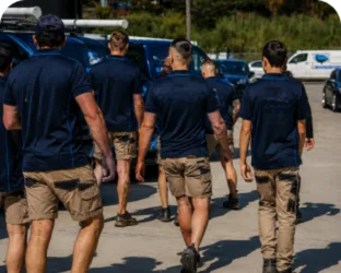 Plumbers walking to their service vans on a Seven Hills job